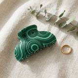 Side profile of emerald malachite claw clip showing gold spring