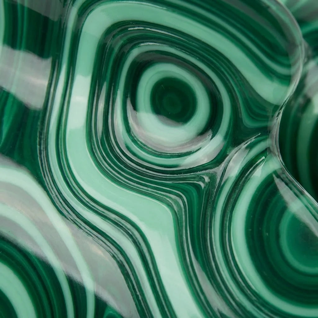 Flat lay of emerald malachite claw clip on linen