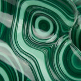 Flat lay of emerald malachite claw clip on linen