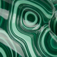 Flat lay of emerald malachite claw clip on linen